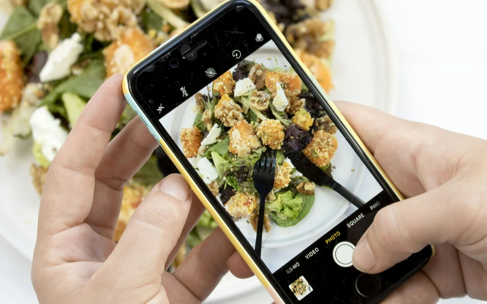 Person using an iPhone camera to capture a meal
